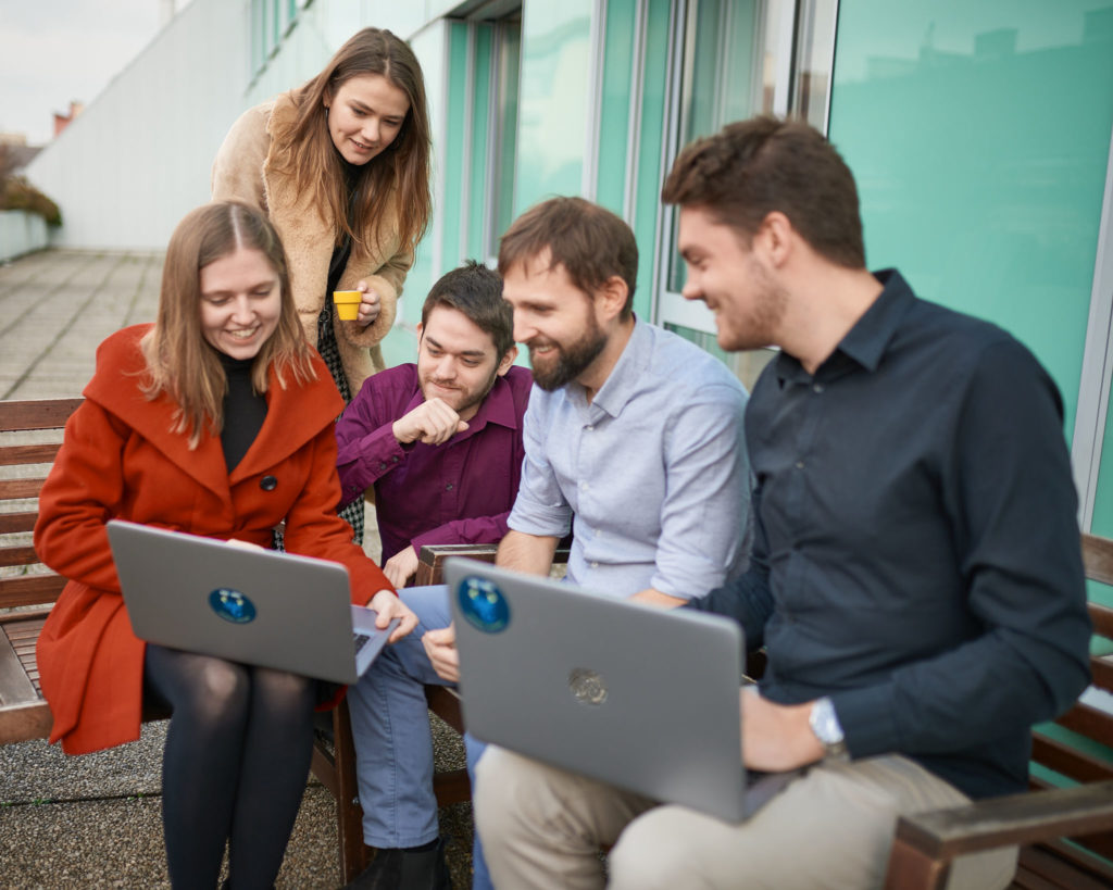 Employees sitting on the terrace and working together