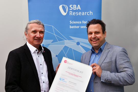 Ceremonial handover of the ISO certificate with Wolfgang Resch (OCG) and Stefan Jakoubi (SBA Professional Services).