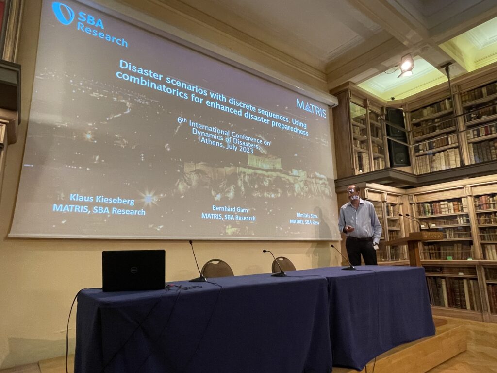 Dimitris presenting on stage