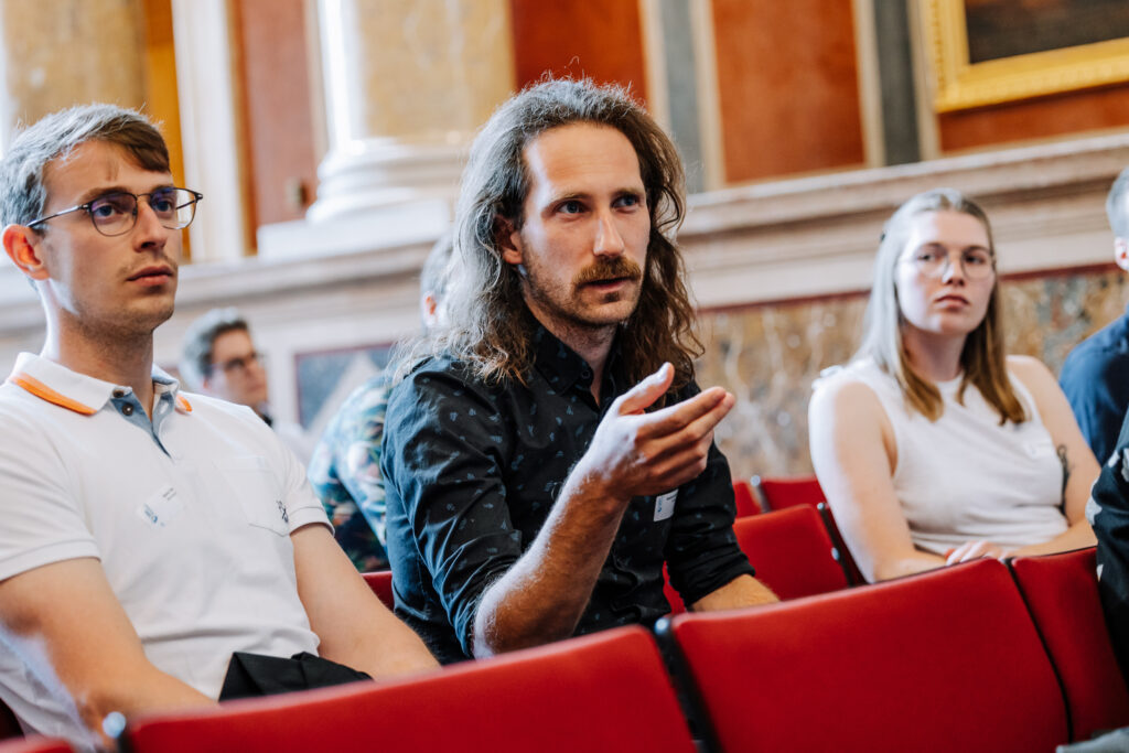 Sebastian Raubitzek sits in audience at SBA´s IMPACT and gives notes