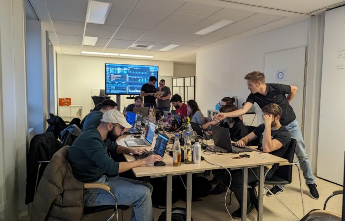 Capture the flag participants sit at table and solve the CTF