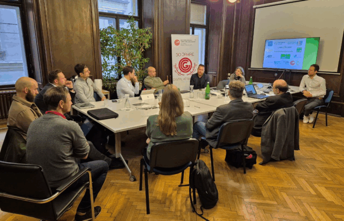 working group members sitting around a table and discussing