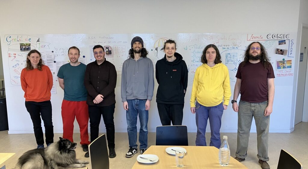 Damast Research Group in front of white wall in the social room