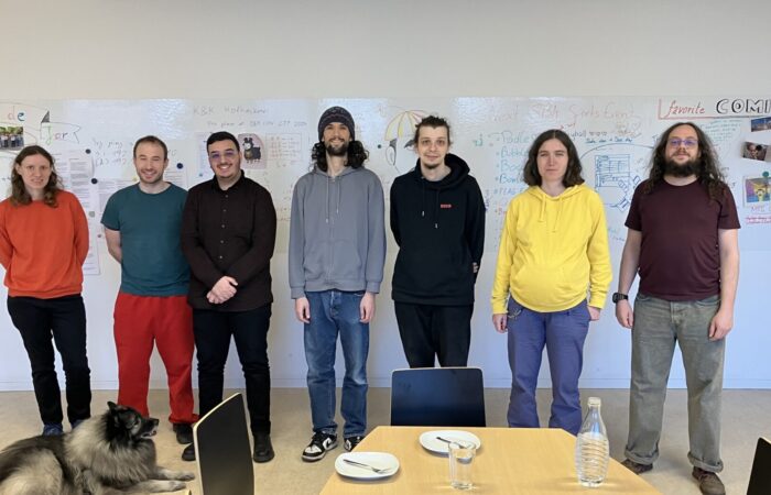 Damast Research Group in front of white wall in the social room