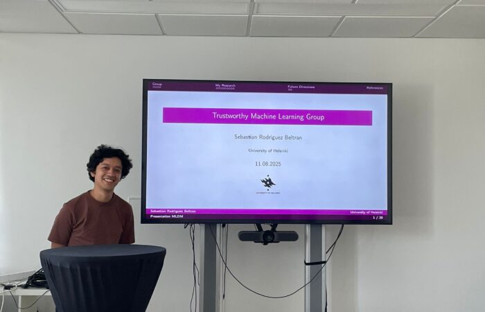 Sebastian Rodriguez Beltran in front of big tv screen during his presentation