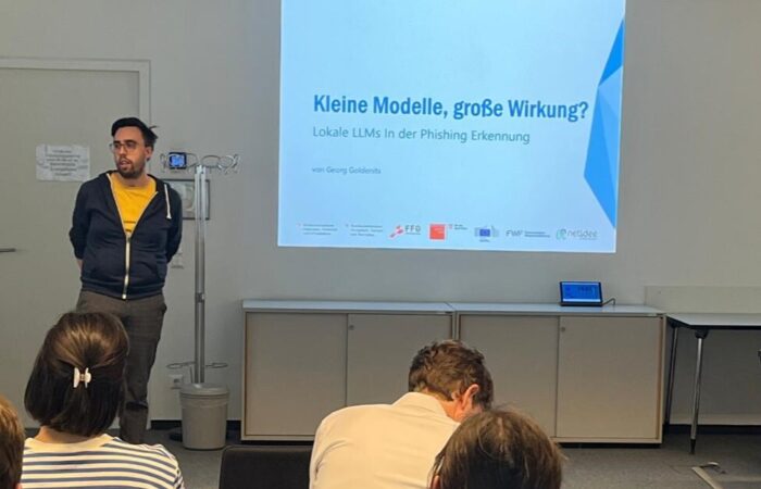 Georg Goldenits presenting on stage
